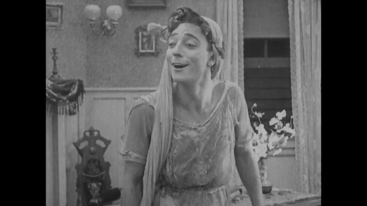Buster Keaton smiling in drag